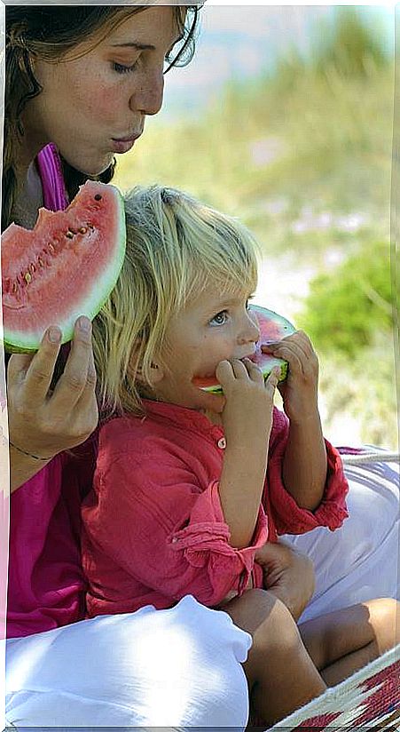 Mother and daughter with watermelon