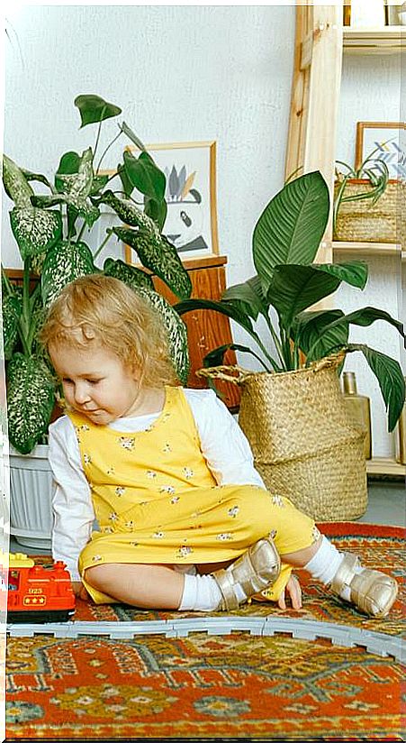 Children playing in a dining room with plants